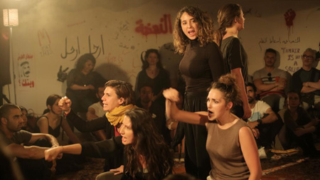 A production shot from Greene’s Nahda: five visions of an Arab awakening at Shubbak Festival 2015, Bush Theatre, London. Pictured (l to r): Waj Ali (seated), Rania Kurdi, Rosie Frascona, Nadia Lamin, Lara Sawalha, and Taghrid Choucair-Vizoso. Photo by Dalia Naber.